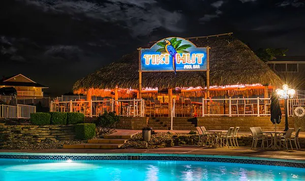 https://margaritaville-resorts.com/wp-content/uploads/2025/07/tiki-bar-poolside-at-nightresize.webp